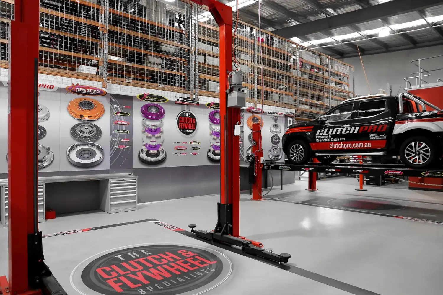 Xtreme Outback R&D workshop with clutch product displays, ClutchPro vehicle, and warehouse facility